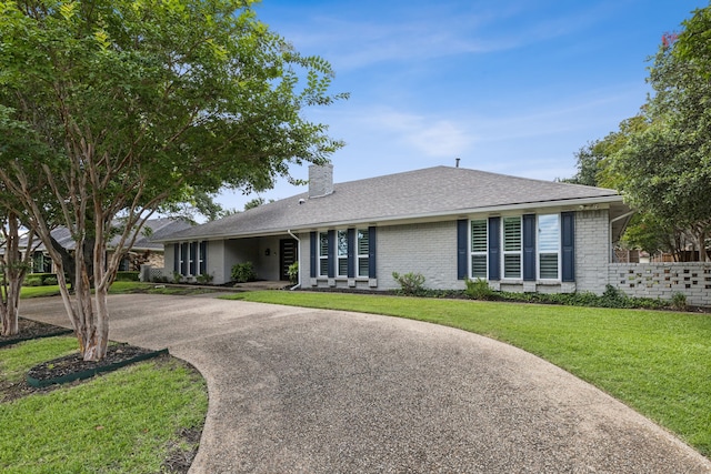 6714 Barkworth Dr, Dallas, TX 75248 - ranch-style house featuring a chimney, concrete driveway, a front lawn, brick siding, and a shingled roof