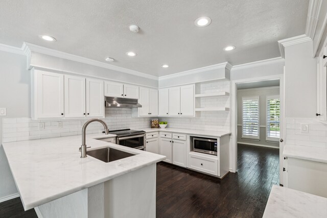 6714 Barkworth Dr, Dallas, TX 75248 - kitchen with appliances with stainless steel finishes, under cabinet range hood, open shelves, a peninsula, and white cabinetry