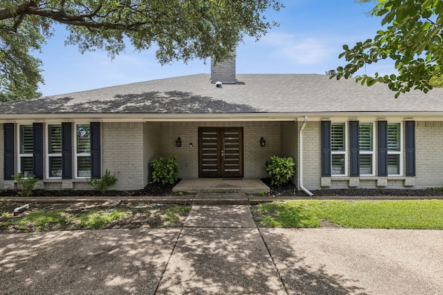 6714 Barkworth Dr, Dallas, TX 75248 - view of front of property with brick siding, a chimney, a shingled roof, and french doors