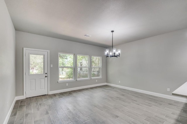 2517 Meaders Ave, Fort Worth, TX 76112 - unfurnished dining area featuring a chandelier and wood finished floors