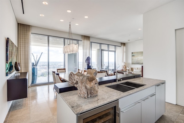 1717 Arts Plz Unit 1808, Dallas, TX 75201 - kitchen with an island with sink, recessed lighting, healthy amount of natural light, wine cooler, and open floor plan