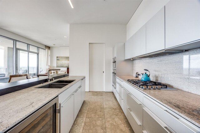 1717 Arts Plz Unit 1808, Dallas, TX 75201 - kitchen with appliances with stainless steel finishes, tasteful backsplash, white cabinets, light stone counters, and recessed lighting