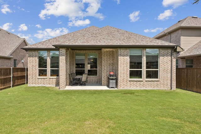 12229 Prudence Dr, Fort Worth, TX 76052 - rear view of house with a fenced backyard, brick siding, and a patio area