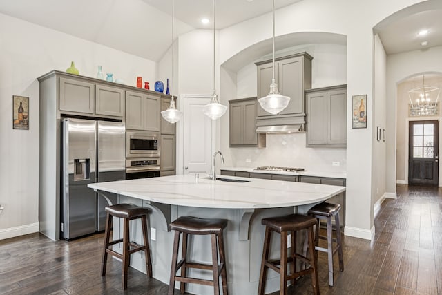 12229 Prudence Dr, Fort Worth, TX 76052 - kitchen featuring stainless steel appliances, gray cabinetry, arched walkways, decorative backsplash, and recessed lighting
