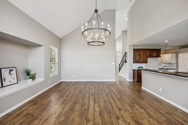 1613 Country Brook Ln, Allen, TX 75002 - kitchen featuring high vaulted ceiling, a chandelier, dark wood-style flooring, dark countertops, and open floor plan