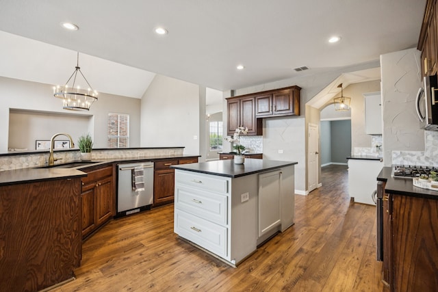 1613 Country Brook Ln, Allen, TX 75002 - kitchen featuring stainless steel appliances, a center island with sink, dark countertops, backsplash, and recessed lighting
