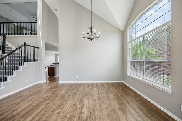 1613 Country Brook Ln, Allen, TX 75002 - unfurnished living room with a chandelier, wood finished floors, stairway, and high vaulted ceiling