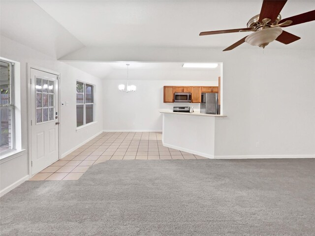 122 Driftwood Ln, Waxahachie, TX 75165 - unfurnished living room with a chandelier, light carpet, light tile patterned flooring, ceiling fan, and plenty of natural light