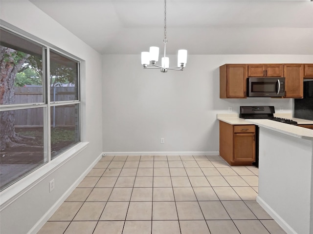 122 Driftwood Ln, Waxahachie, TX 75165 - kitchen featuring stainless steel microwave, brown cabinets, a chandelier, light countertops, and vaulted ceiling