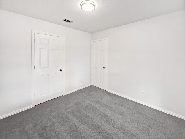 122 Driftwood Ln, Waxahachie, TX 75165 - empty room with dark colored carpet and baseboards