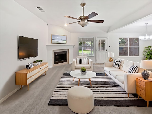 122 Driftwood Ln, Waxahachie, TX 75165 - living room with a ceiling fan, a fireplace, a chandelier, vaulted ceiling, and light carpet