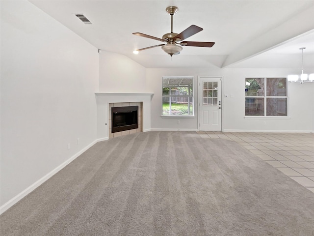 122 Driftwood Ln, Waxahachie, TX 75165 - unfurnished living room with ceiling fan, a fireplace, vaulted ceiling, a chandelier, and tile patterned flooring