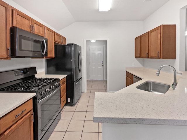 122 Driftwood Ln, Waxahachie, TX 75165 - kitchen with black range with gas stovetop, lofted ceiling, brown cabinetry, light tile patterned floors, and light stone counters
