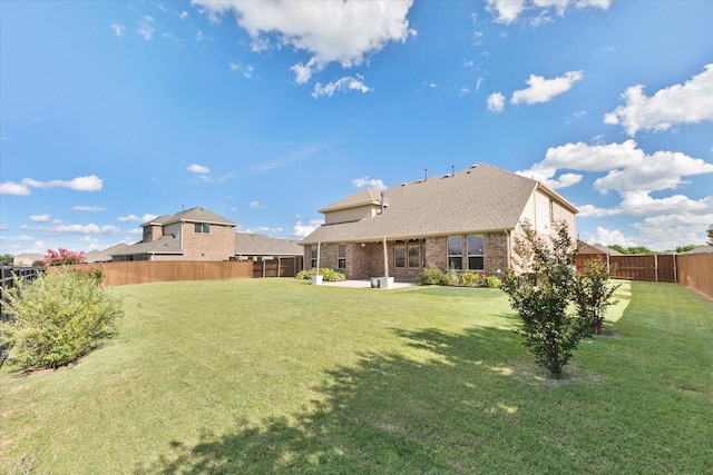 3204 Wimberley Ln, Rockwall, TX 75032 - back of property with a fenced backyard, a patio area, and brick siding
