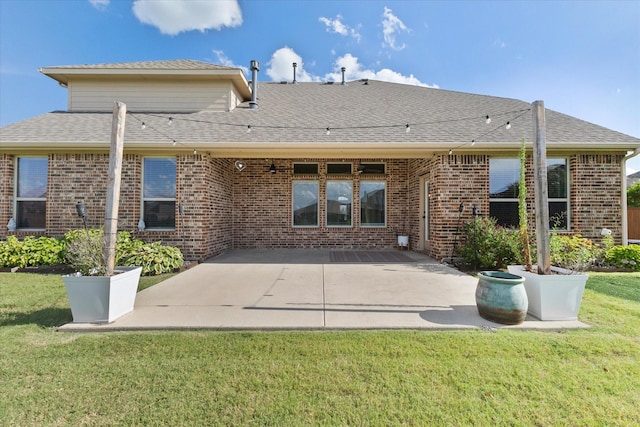 3204 Wimberley Ln, Rockwall, TX 75032 - rear view of house with brick siding, a patio area, and a lawn