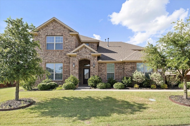 3204 Wimberley Ln, Rockwall, TX 75032 - view of front of property featuring brick siding, a front lawn, and roof with shingles