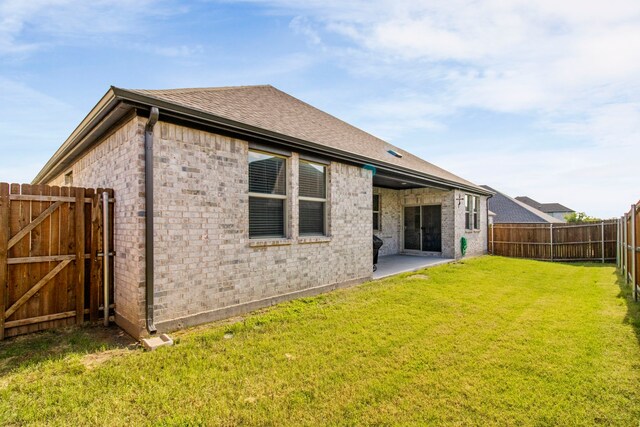1211 Sweetleaf St, Melissa, TX 75454 - back of house featuring a fenced backyard, a shingled roof, brick siding, and a gate