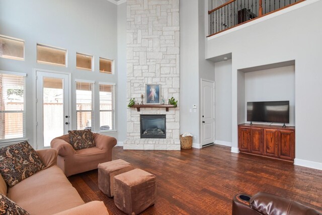 9750 Candlewood Dr, Frisco, TX 75033 - living area with a towering ceiling, a stone fireplace, and dark wood-style floors