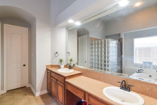 9750 Candlewood Dr, Frisco, TX 75033 - bathroom featuring double vanity, tile patterned flooring, a bath, a shower, and recessed lighting