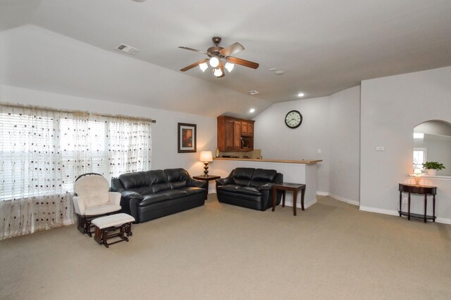 9750 Candlewood Dr, Frisco, TX 75033 - living area featuring lofted ceiling, light colored carpet, a ceiling fan, and arched walkways