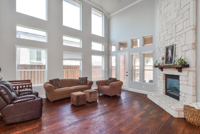 9750 Candlewood Dr, Frisco, TX 75033 - living room with a fireplace, high vaulted ceiling, ornamental molding, and dark wood-type flooring