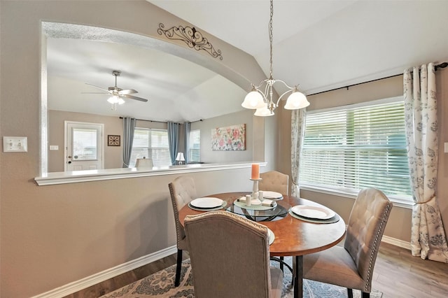 9210 Wild River Dr, Arlington, TX 76002 - dining area with vaulted ceiling, wood finished floors, a chandelier, and a ceiling fan