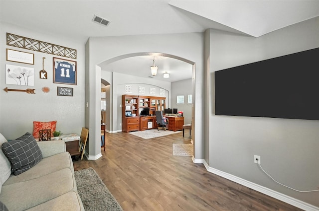 9210 Wild River Dr, Arlington, TX 76002 - living area featuring arched walkways, a desk, and wood finished floors