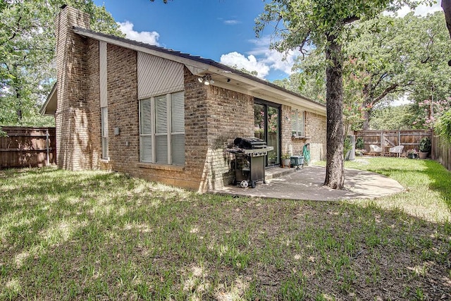 5800 Thoreau Ln, Arlington, TX 76016 - back of house featuring brick siding, a chimney, a fenced backyard, and a patio area