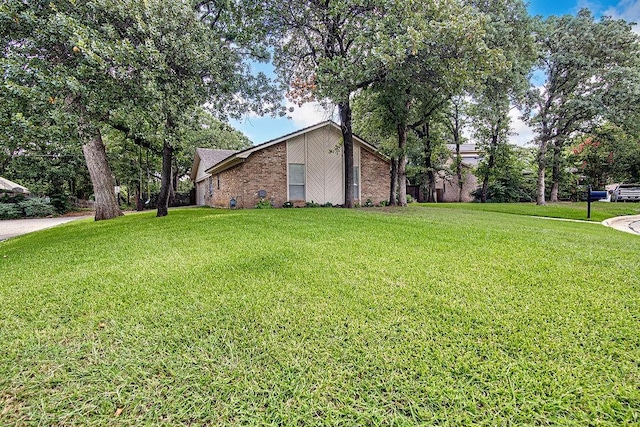 5800 Thoreau Ln, Arlington, TX 76016 - view of property exterior with a lawn and brick siding
