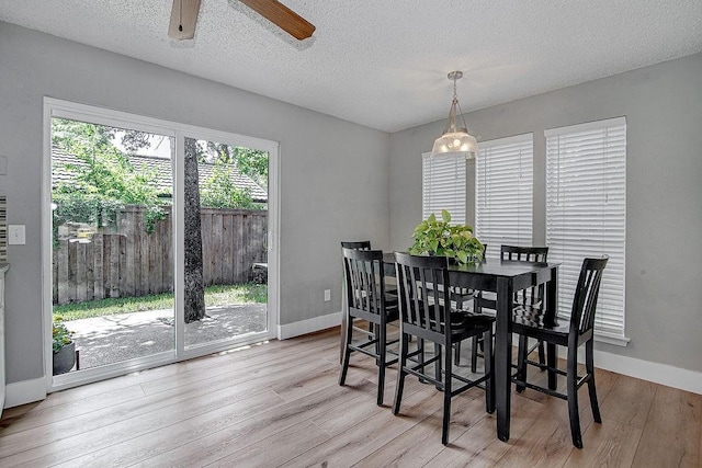 5800 Thoreau Ln, Arlington, TX 76016 - dining space featuring light wood-style flooring, a textured ceiling, and a ceiling fan