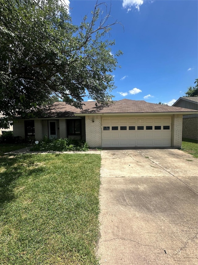 416 Meadowhill Dr, Garland, TX 75043 - single story home with an attached garage, concrete driveway, a front lawn, and brick siding