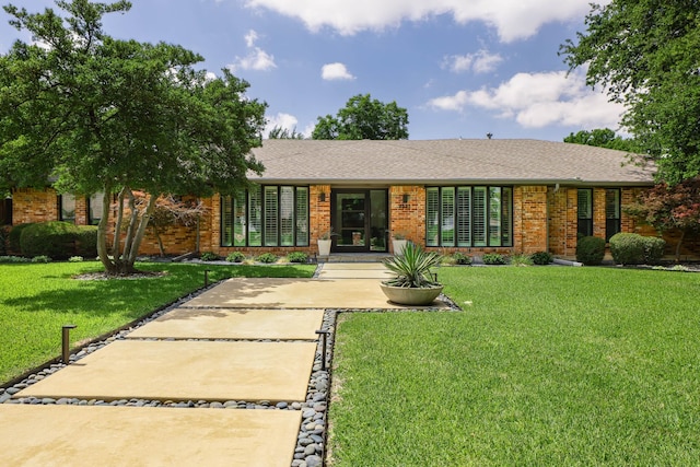 4232 Meadowdale Ln, Dallas, TX 75229 - view of front facade featuring brick siding, a front lawn, and a shingled roof