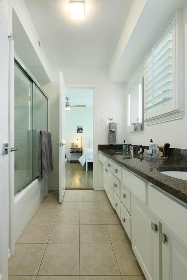 4232 Meadowdale Ln, Dallas, TX 75229 - bathroom with ensuite bathroom, double vanity, tile patterned floors, and combined bath / shower with glass door