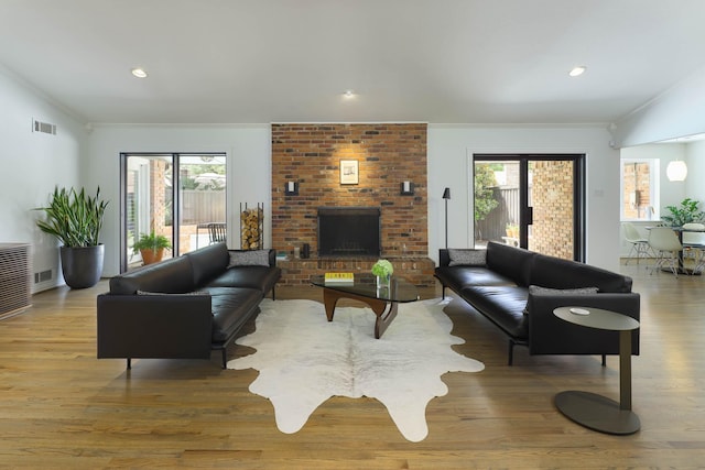 4232 Meadowdale Ln, Dallas, TX 75229 - living room featuring crown molding, wood finished floors, a fireplace, and recessed lighting