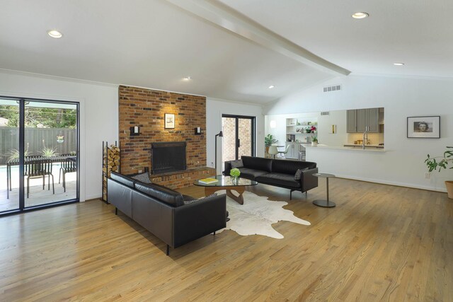 4232 Meadowdale Ln, Dallas, TX 75229 - living area featuring light wood-style floors, a brick fireplace, and recessed lighting