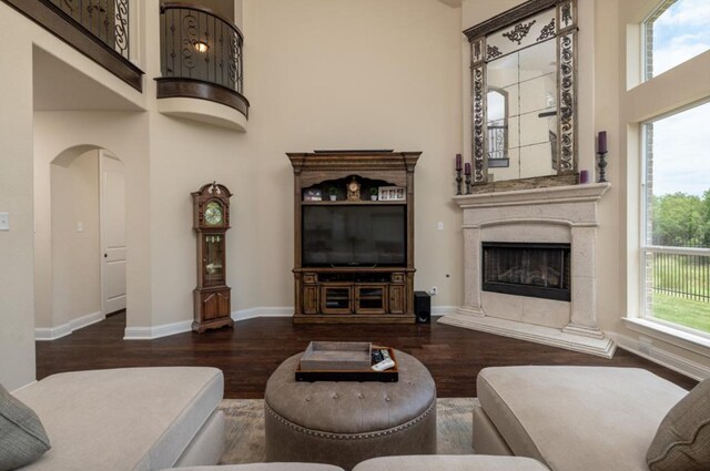 6812 S Fork Dr, North Richland Hills, TX 76182 - living room with a towering ceiling, wood finished floors, a high end fireplace, and arched walkways