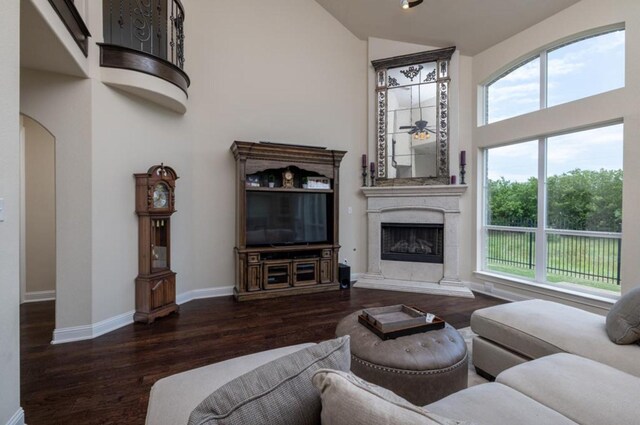 6812 S Fork Dr, North Richland Hills, TX 76182 - living room with high vaulted ceiling, wood finished floors, a fireplace with raised hearth, and arched walkways