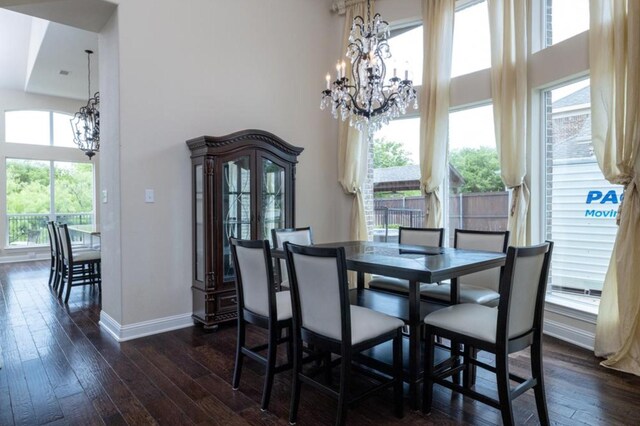 6812 S Fork Dr, North Richland Hills, TX 76182 - dining room featuring a chandelier, a towering ceiling, dark wood finished floors, and plenty of natural light