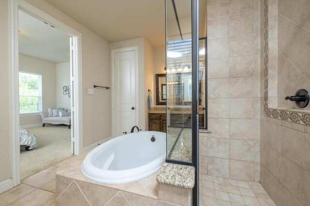 6812 S Fork Dr, North Richland Hills, TX 76182 - bathroom with ensuite bath, a bath, a tile shower, and tile patterned floors