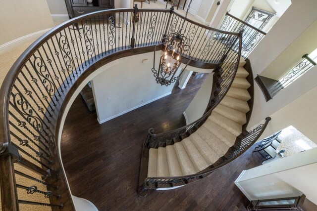 6812 S Fork Dr, North Richland Hills, TX 76182 - staircase featuring a towering ceiling, wood finished floors, and arched walkways