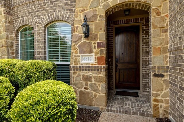 6812 S Fork Dr, North Richland Hills, TX 76182 - property entrance with brick siding and stone siding