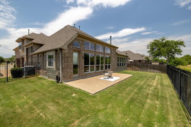 6812 S Fork Dr, North Richland Hills, TX 76182 - back of property with brick siding, a fenced backyard, a patio area, and roof with shingles