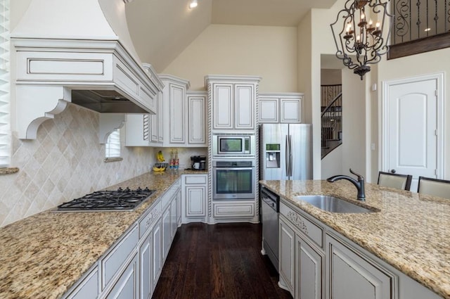 6812 S Fork Dr, North Richland Hills, TX 76182 - kitchen with appliances with stainless steel finishes, a chandelier, dark wood-style flooring, lofted ceiling, and tasteful backsplash