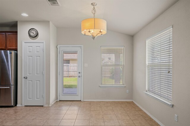6521 La Sol Ln, Waco, TX 76712 - unfurnished dining area with vaulted ceiling and light tile patterned floors