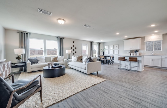 7518 Fenton Pkwy, Pilot Point, TX 76258 - living room with recessed lighting and light wood-style flooring