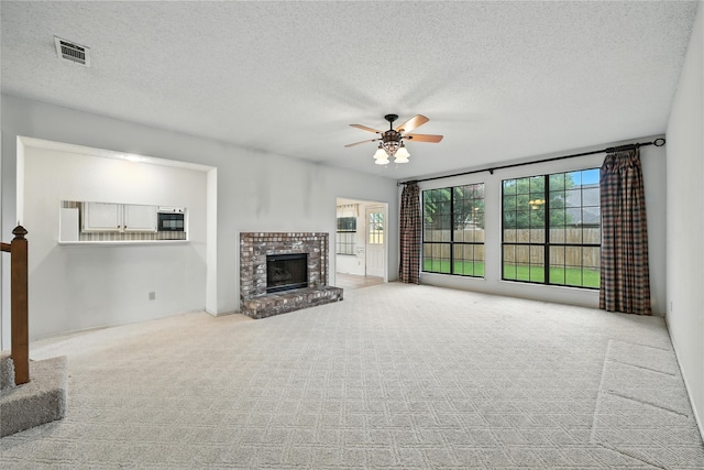 2116 S Winding Creek Dr, Grapevine, TX 76051 - unfurnished living room with a ceiling fan, carpet, a brick fireplace, and a textured ceiling