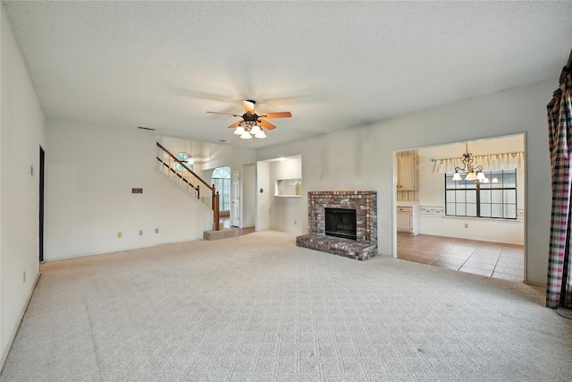 2116 S Winding Creek Dr, Grapevine, TX 76051 - unfurnished living room featuring carpet flooring, stairs, a ceiling fan, a chandelier, and a fireplace