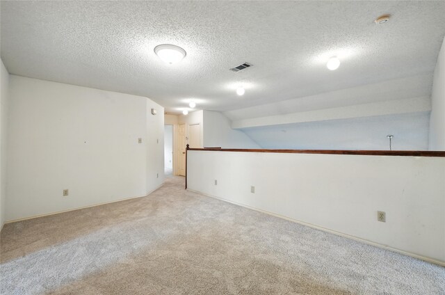 2116 S Winding Creek Dr, Grapevine, TX 76051 - spare room with light colored carpet, a smoke detector, a textured ceiling, and lofted ceiling
