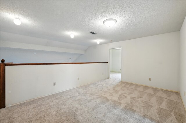 2116 S Winding Creek Dr, Grapevine, TX 76051 - carpeted spare room featuring a textured ceiling and vaulted ceiling