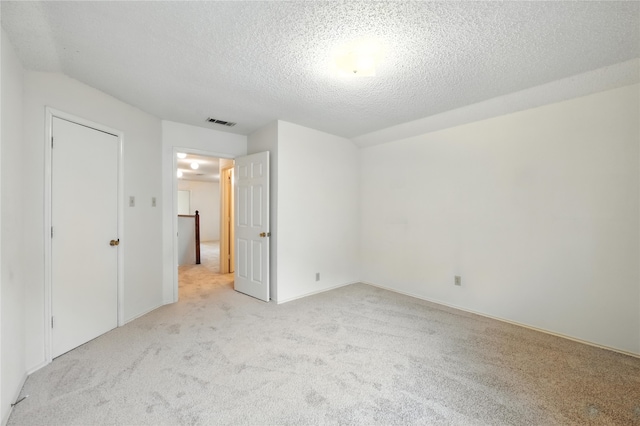 2116 S Winding Creek Dr, Grapevine, TX 76051 - unfurnished bedroom featuring light colored carpet and a textured ceiling